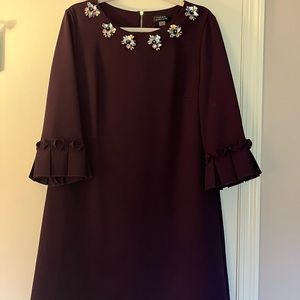 Tahari beautifully embellished plum color cocktail dress with bell sleeves.